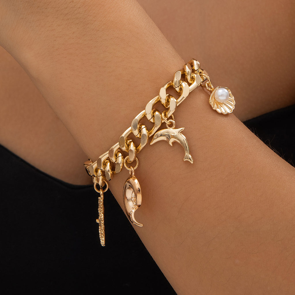 Dolphin and conch charm detail on choker