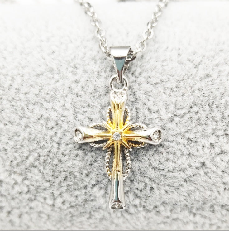 Star and cross pendant necklace worn on model